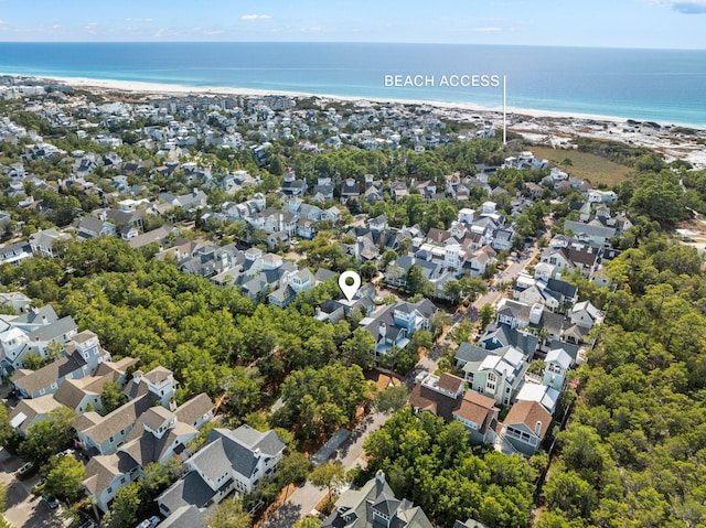 drone / aerial view featuring a water view and a view of the beach