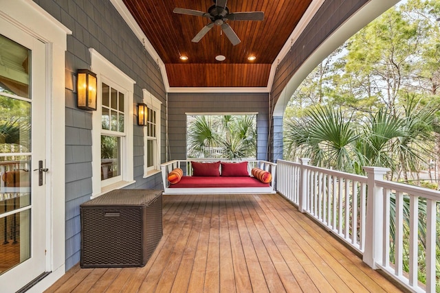 wooden terrace featuring ceiling fan