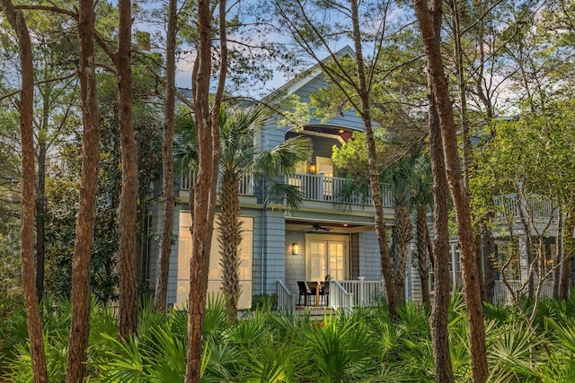 view of front of house with a porch, ceiling fan, and a balcony