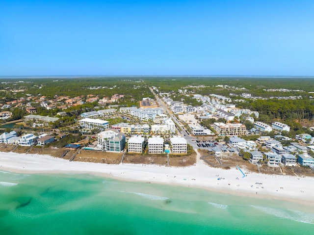 bird's eye view featuring a water view and a beach view