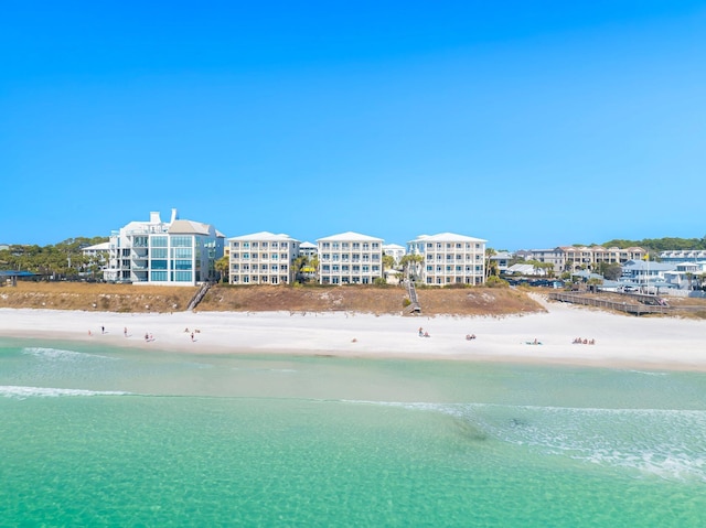 drone / aerial view with a water view and a beach view