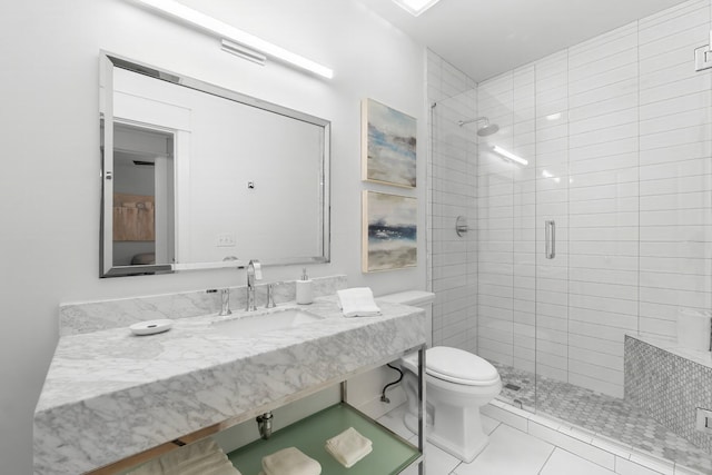 bathroom featuring toilet, tile patterned floors, sink, and a shower with door