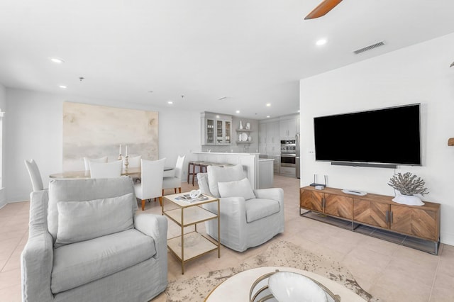 tiled living room with ceiling fan