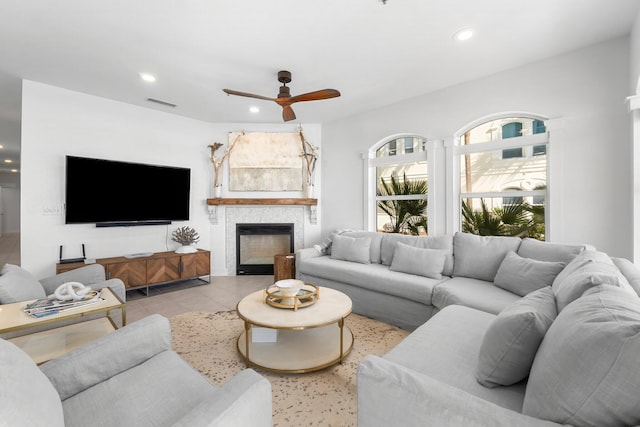 living room featuring ceiling fan and light tile patterned flooring