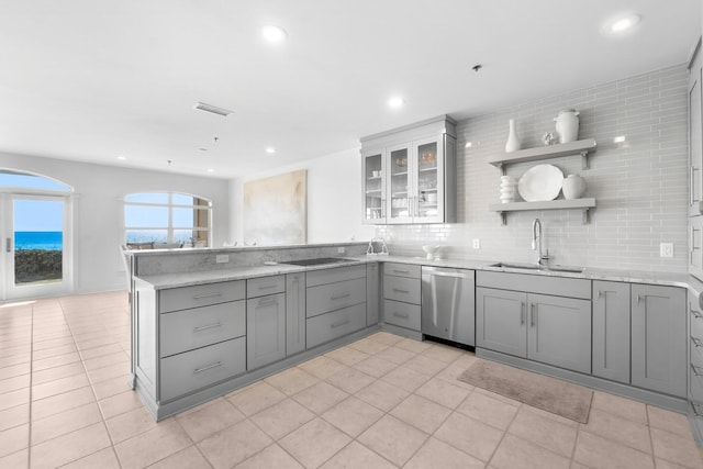 kitchen with stainless steel dishwasher, sink, decorative backsplash, and gray cabinetry