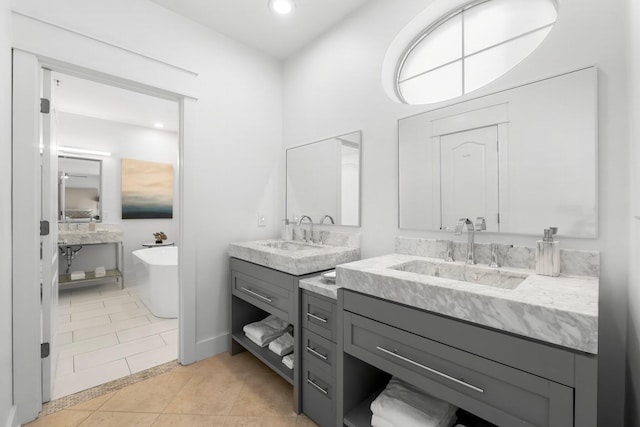 bathroom featuring tile patterned flooring, vanity, and a bathing tub