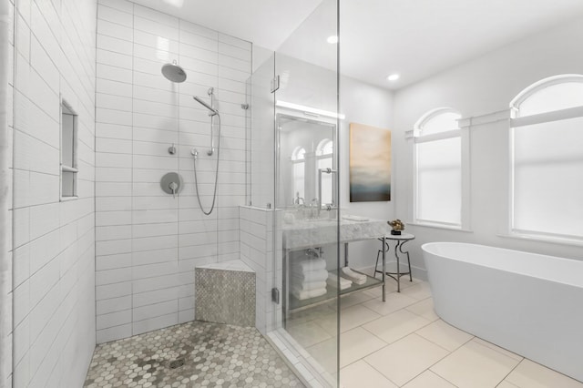 bathroom featuring shower with separate bathtub and tile patterned flooring