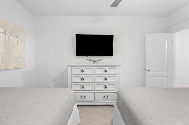 tiled bedroom featuring ceiling fan