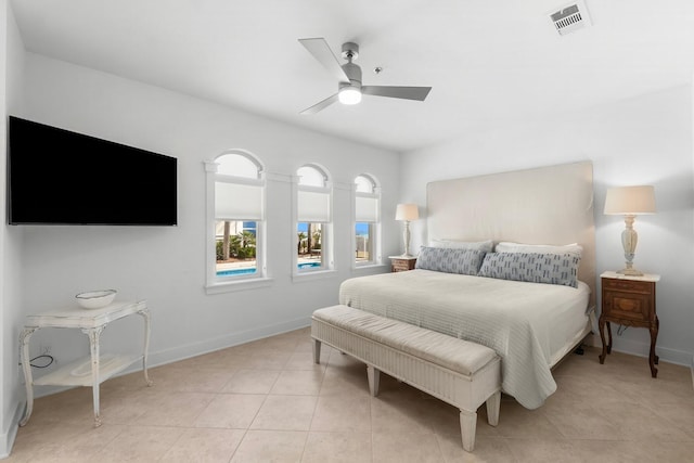 tiled bedroom featuring ceiling fan