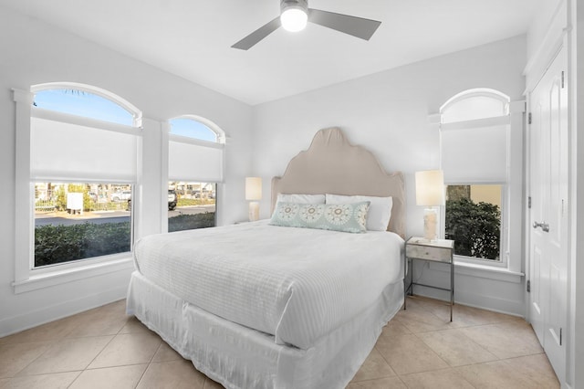 bedroom with ceiling fan and light tile patterned flooring