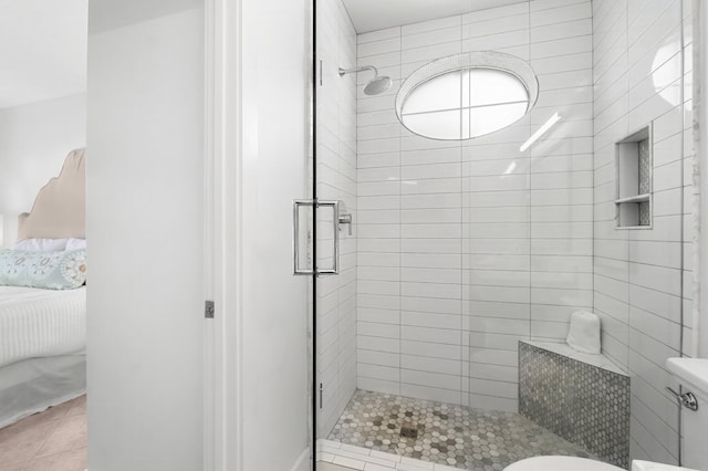 bathroom featuring tile patterned floors, toilet, and walk in shower