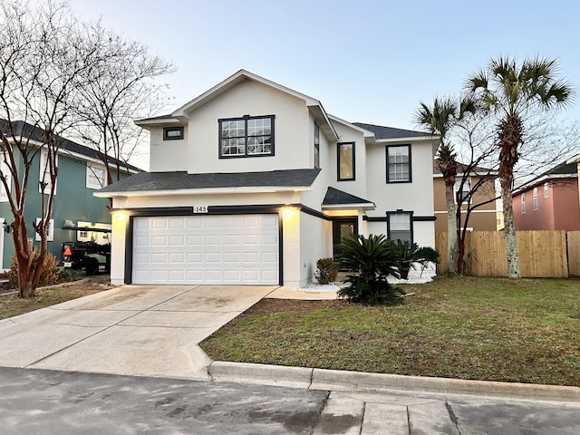 front facade featuring a garage and a front lawn