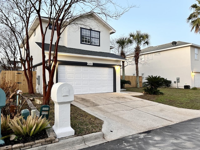 view of property with a garage and a front lawn