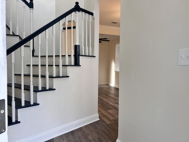 stairway with crown molding, hardwood / wood-style floors, and ceiling fan