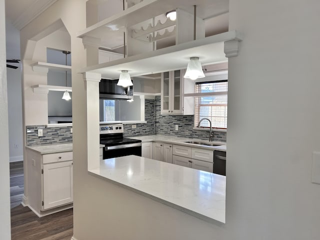 kitchen featuring appliances with stainless steel finishes, sink, backsplash, white cabinets, and light stone counters