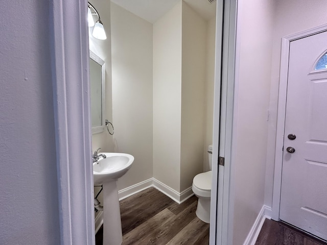 bathroom with wood-type flooring, sink, and toilet