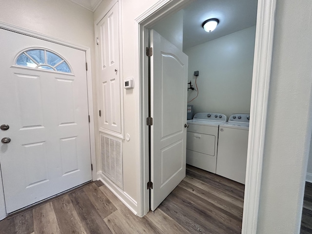 laundry area with hardwood / wood-style flooring and washing machine and clothes dryer