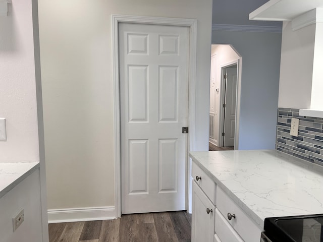 bathroom with wood-type flooring, backsplash, and crown molding