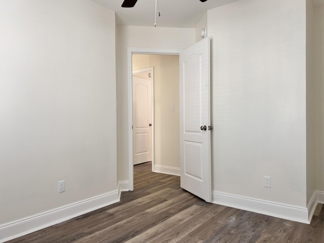 empty room with dark wood-type flooring and ceiling fan