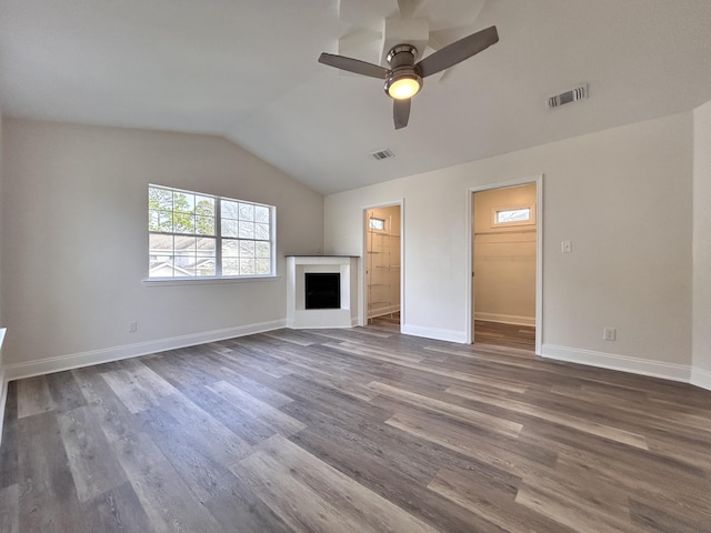 unfurnished living room featuring lofted ceiling, dark wood-type flooring, and ceiling fan