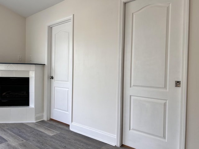 unfurnished living room with dark hardwood / wood-style floors and a fireplace