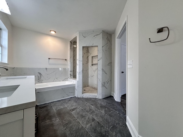 bathroom featuring vanity and independent shower and bath