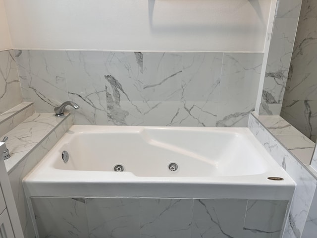 bathroom featuring a relaxing tiled tub