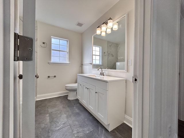 bathroom with walk in shower, vanity, and toilet