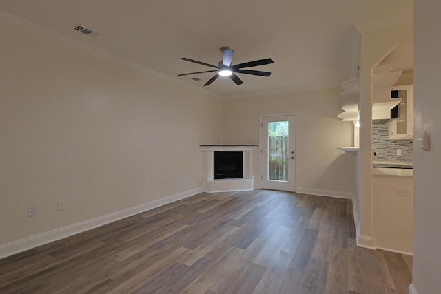 149 Legion Park Loop, Miramar Beach, FL 32550 - unfurnished living room with dark wood finished floors, ornamental molding, a ceiling fan, a fireplace with raised hearth, and baseboards