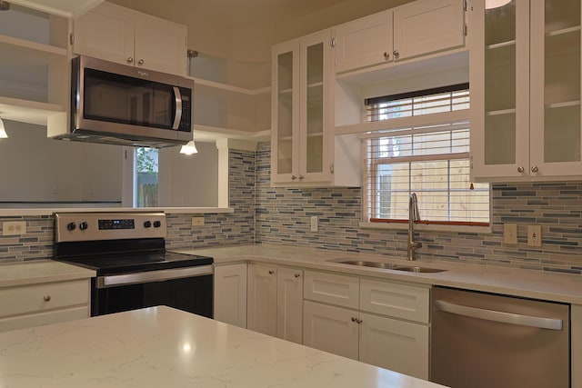 149 Legion Park Loop, Miramar Beach, FL 32550 - kitchen with appliances with stainless steel finishes, a sink, backsplash, white cabinetry, and open shelves