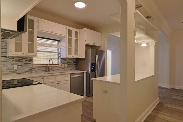 149 Legion Park Loop, Miramar Beach, FL 32550 - kitchen with a sink, stainless steel appliances, wood finished floors, decorative backsplash, and white cabinetry
