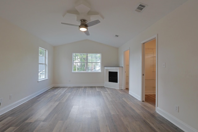 149 Legion Park Loop, Miramar Beach, FL 32550 - unfurnished living room featuring vaulted ceiling, a fireplace, wood finished floors, a ceiling fan, and baseboards