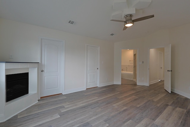 149 Legion Park Loop, Miramar Beach, FL 32550 - unfurnished living room with wood finished floors, a fireplace, a ceiling fan, baseboards, and vaulted ceiling