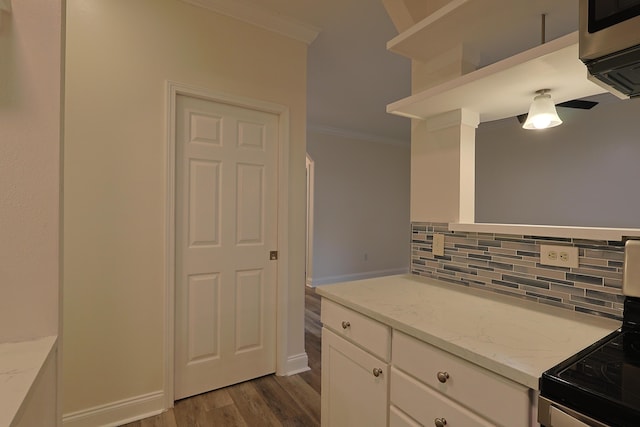 149 Legion Park Loop, Miramar Beach, FL 32550 - kitchen with ornamental molding, backsplash, range with electric stovetop, dark wood-style floors, and white cabinets