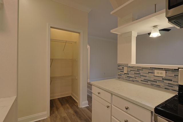 149 Legion Park Loop, Miramar Beach, FL 32550 - kitchen with backsplash, ornamental molding, electric stove, white cabinetry, and dark wood-type flooring