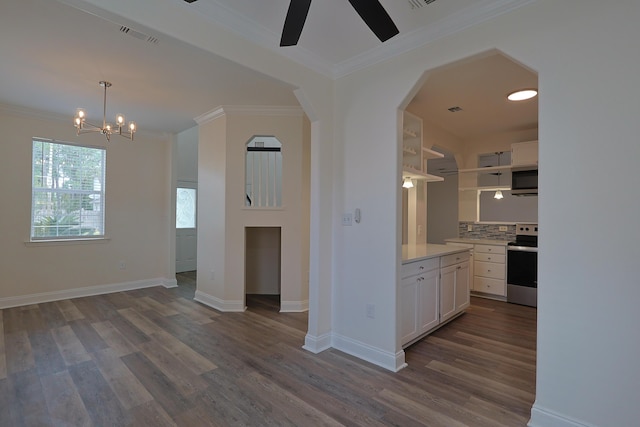 149 Legion Park Loop, Miramar Beach, FL 32550 - kitchen featuring stainless steel appliances, crown molding, open shelves, dark wood-type flooring, and light countertops