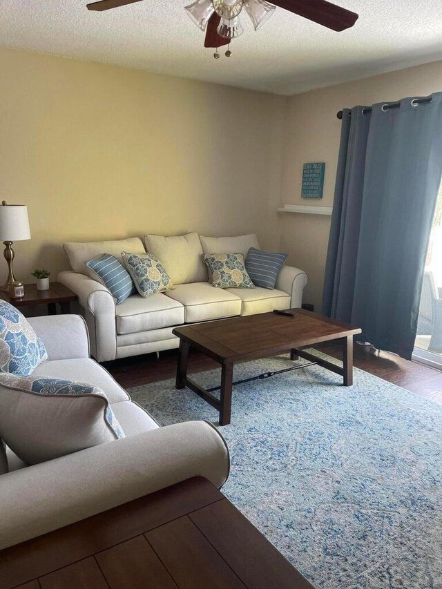 8468 Gulf Blvd # Ut-4, Navarre, FL 32566 - living room featuring a textured ceiling, dark wood-type flooring, and ceiling fan
