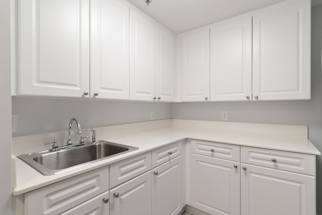 kitchen featuring sink and white cabinets