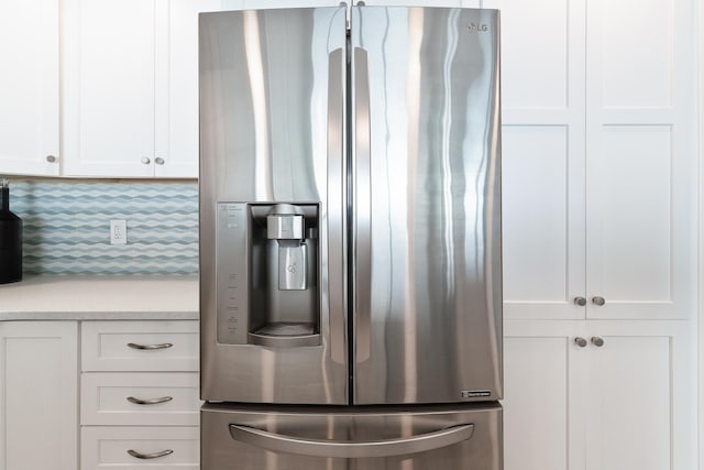 kitchen with white cabinetry and stainless steel fridge with ice dispenser