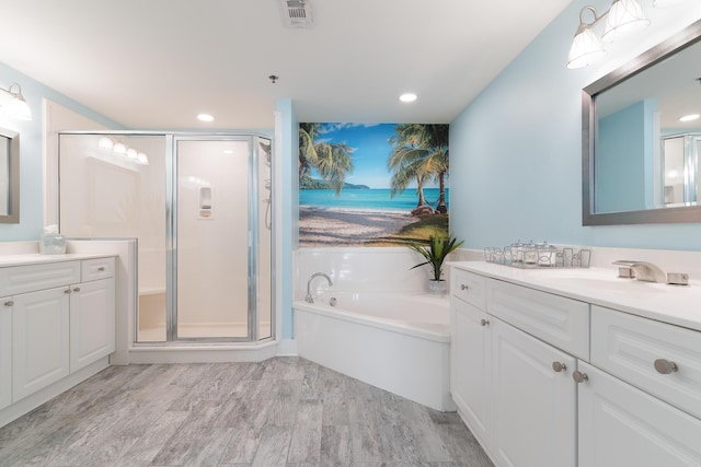 bathroom with vanity, hardwood / wood-style floors, and independent shower and bath