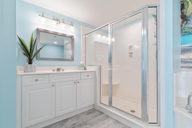 bathroom featuring vanity and a shower with shower door