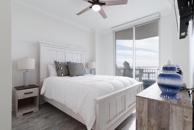 bedroom featuring expansive windows, ornamental molding, dark wood-type flooring, and access to outside