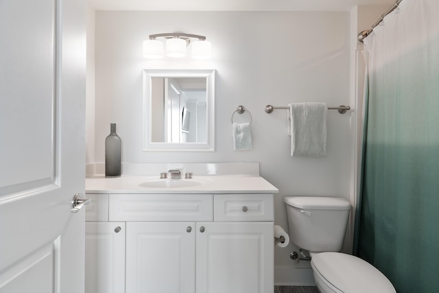 bathroom featuring vanity and toilet