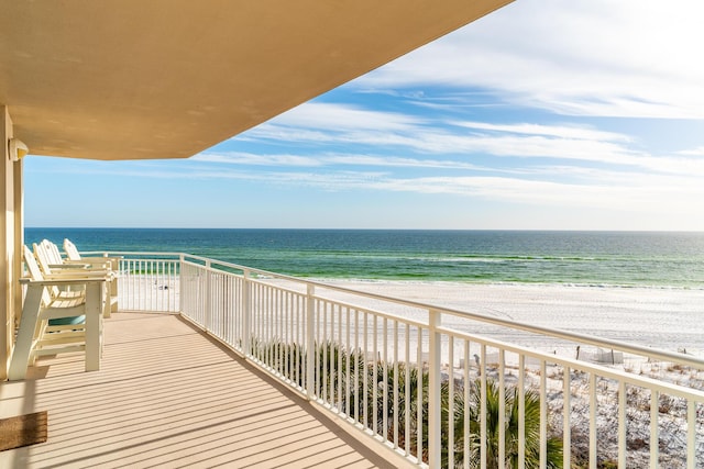 balcony with a beach view and a water view