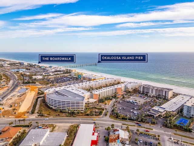 drone / aerial view with a beach view and a water view