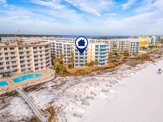 bird's eye view with a water view and a beach view