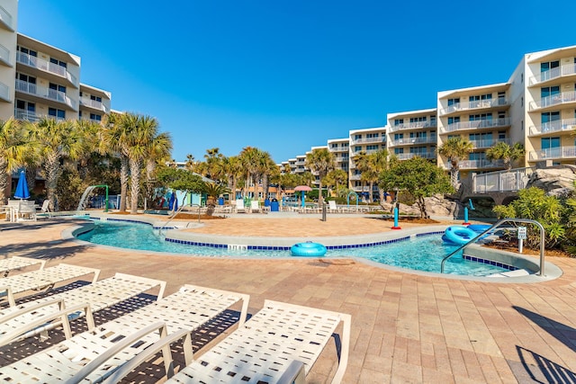 view of pool featuring pool water feature and a patio area