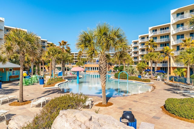 view of swimming pool with pool water feature