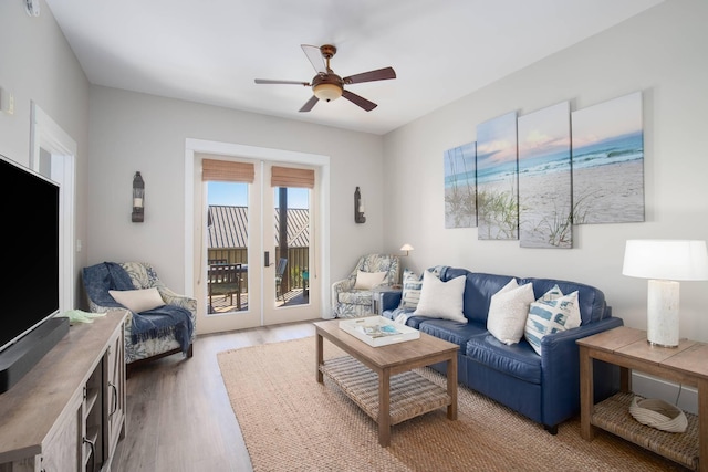 living room with wood finished floors and a ceiling fan