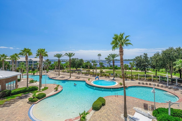 view of pool with a patio area and a hot tub